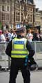 View: a00988 A policemen faces protesters against an English Defence League (EDL) visit to Sheffield