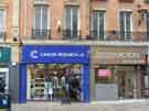 View: a03525 Shops on Pinstone Street showing (l. to r.) Cancer Research UK (No.28) and Best Solicitors (No.26)