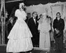 View: arc00301 T. B. and W. Cockayne, department store, Nos. 1 - 13 Angel Street - Queen Mary (1867-1953) inspecting an 1851 wedding dress