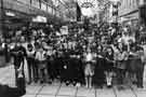 View: s30475 Rowlinson Secondary School choir carol singing on the Moor