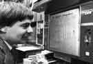 View: s31872 Martin Olive, Local Studies Librarian, viewing a newspaper on microfilm in the Local Studies Library, Central Library, Surrey Street