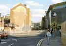 Steelworker brick mural by Paul Waplington on the wall of No. 11 Castle Street and junction with Castle Street with GT News Kiosk in front, (No.11) and Snig Hill