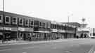 View: s38564 Nos.15-27 London Road showing (left to right) Black and Decker Ltd, power tools dealers (No.15); Moorfoot News, newsagents (No.17); H.L.White, opticians (No.17a); unknown fish and chips shop (No.19) and Ladbroke and Co. Ltd, bookmakers (No.21)  