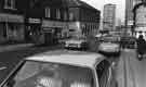 View: s38574 London Road showing (left) The Tile Shop (No.148); London Road Laundrette (No.146) and Beltons, kitchen furniture dealers (Nos.140-144) and (right) Eric and Nellie Hadfield, ladies hairdressers (No.143) 