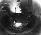 View: s40743 Swift Levick and Sons Ltd., Clarence Steel Works, Foley Street showing molten steel running from the ladle into ingot molds, c. 1960