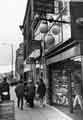 View: s41416 Shops on Pinstone Street showing (No.74) Herbert Brown, jeweller and pawnbroker and (No.76) Dolland and Aitchison, opticians