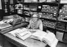 View: s41614 Enid Gilberthorpe, librarian, Arts and Humanities Library, Sheffield City Libraries, Central Library, Surrey Street shown working in the Local Studies office