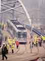 View: s42393 Supertram arriving after its inaugural run from the Nunnery Depot, off the Parkway, along the viaduct, across Park Square and onto Commercial Street