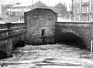 View: s43893 River Don in flood at confluence with the River Sheaf at junction of Blonk Street and Castlegate showing (centre) public lavatories