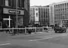 View: s44323 Construction of Castle Square showing (left) No. 47 Manfield and Sons Ltd., shoe shop, (centre) Royal Exchange Buildings and (right) Peter Robinson Ltd., department store, Nos. 51 - 57 High Street