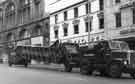 View: s44333 High Street showing the transportation of escalators for the construction of Castle Square and (back) No, 29 Dolcis Ltd., shoe shop and No. 31 Old Blue Bell public house 