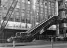 View: s44335 High Street and the lifting of escalators for the construction of Castle Square showing (back) J.Walsh and Co., department store