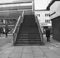 View: s44470 Footbridge over Haymarket showing (left) Nos.12-18 British Home Stores and (right) Nos.8-10 Trueform, shoe shop