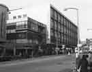 View: s44669 Shops on The Moor showing (left) at junction with Rockingham Way, Nos.16-18 Dixons, photographic equipment, audio visual and electronics store and (right) Debenhams, department store