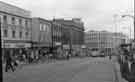 View: s44809 High Street showing (left) Manfield and Sons Ltd., shoe shop; No.31 The Old Blue Bell public house and Nos. 59 - 65 C and A Modes Ltd., department store