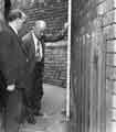 View: s44861 Joe Street (City Engineers Department) and Bert Hawley (Dangerous Structures section) inspect a wall at No. 42 Nicholson Road, Heeley