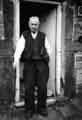 View: t09680 Man standing in doorway