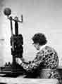 View: t09695 Woman working on a single ball fly press.