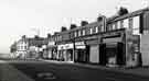 View: t11240 Shops on Spital Hill showing (r. to l.) No. 157 Soofi M. Khan, continental food stores, No. 155 H. Marriott and Sons Ltd., leather factors, No. 153 Eastern Orbit, menswear, No. 151 Smiths Cleaners and No.149 A. W. Gent, opticians