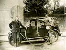 Car and penny farthing bicycle at unidentified location