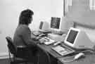 View: u10118 Jacqui Chase, library staff member, using a computer at the Central Library, Surrey Street