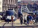 View: u10439 Supertram at the Fitzalan Square / Ponds Forge stop on Commercial Street showing Park Square Supertram bridge (centre)