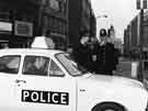 View: u10481 Panda police car on Fargate showing (left) No. 58 Burnley Building Society and Nos. 54 - 56 The Golden Egg Restaurant 