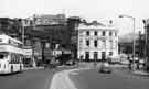 View: u10517 Shops on Waingate looking down towards Lady's Bridge Hotel showing Sugarman Brothers Ltd., house furnishers (No.11); Haywood's Travel Agency (No,13); Hanson's wool shop (No.15); J. Colvin, outfitters (No.17) and Alex Owen