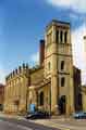 View: v04701 Holy Trinity Church at the junction of Nursery Street and Johnson Street (right) with the chimney of what used to be John Aizelwood Ltd,  Crown Flour Mills in the background