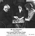 View: y11353 S. H. Pearman instructs Una Senior and Irene Tudor in the noble art of chess at Jessop Saville Ltd.