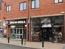 View: a04898 Devonshire Street showing (l. to r.) Nos.116 - 118 Taco Bell, Mexican restaurant and No. 114 Savills, barbers