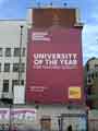 View: a05105 Advertisement for Sheffield Hallam University as 'University of the Year for Teaching Quality'  on the gable end of Central Library on Arundel Gate