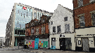 View: a05186 Derelict Henry's cafe bar and Dina, arts venue and diner, Cambridge Street (with new HSBC offices in background)