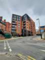 Cross Burgess Street from Burgess Street showing (centre) Burgess House apartments