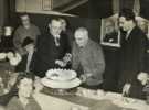 Lord Mayor, Councillor Samuel Hartley Marshall JP and Lady Mayoress Mrs Marshall helping to cut the birthday cake of Tom Bettles, a turner at Fred Cam (Engineers) Ltd., Nos. 1 - 5 John Street