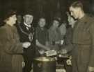 Lord Mayor, Councillor Samuel Hartley Marshall JP and Lady Mayoress, Mrs Marshall helping WVS (Women's Voluntary Service) to serve dinner to soldiers of the Hallamshire Battalion, the York and Lancaster Regiment