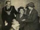 Lord Mayor, Councillor Samuel Hartley Marshall JP and Lady Mayoress, Mrs Marshall presenting a christening spoon to Christine Anne Mortimer, an evacuee who is their godchild, at a ceremony in Lord Mayor's Parlour, Town Hall, Pinstone Street