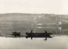 Spreading coke dust on Broomhead reservoir during the construction of the Ewden Valley reservoirs 