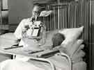 View: h00111 Reading aid in use on Blake Ward, Nether Edge Hospital, c. 1950s