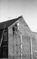 Men working on gable end, c.1970s