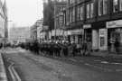 Workers march with brass band, Church Street showing (right) Refuge Assurance Building and No.43 Midland Opticians and No. 45 Smiths, drycleaners, 1970s