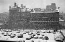 Snowing on Shude Hill showing (back) Canada House (the old Gas Company offices), 1970s