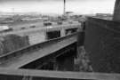 Rail tracks and footbridge under the Parkway showing (back centre) Bernard Road incinerator