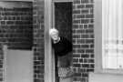 Woman looking out of her door, possibly Woodseats Road