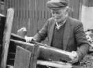 Man collecting firewood from the premises being demolished at rear of General Post Office, Pond Street