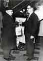 View: s46028 Opening of new Stocksbridge Co-operative Society, Manchester Road, Deepcar showing shop manager presenting a bag of groceries to a customer