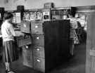 View: s46455 Commerce and Technology Library, Central Library, Surrey Street showing (right) Jean Clark, library assistant, c. late 1950s