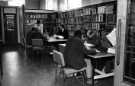 View: s46468 Business Library, Central Library, Surrey Street showing (standing) librarian, Alysoun Bagguely