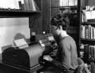 View: s46480 Hazel Tattersall, library assistant, using the telex machine, Commerce and Technology Library, Central Library, Surrey Street 