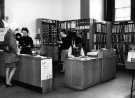 View: s46573 Music Library, Central Library, Surrey Street showing (1st left) librarian, Catherine Pinion, (2nd left) library assistant, Audrey Arthur and (sitting) library assistant Madge Dale